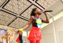 Young singer performing on stage at Antigua Day in New York